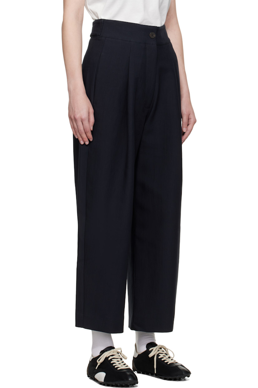 Crinkled cotton-blend twill trousers.

· Four-pocket styling
· Zip fly
· Pleats at front
· Creased legs
· Adjustable button tabs at back waistband

Supplier color: Darkest navy