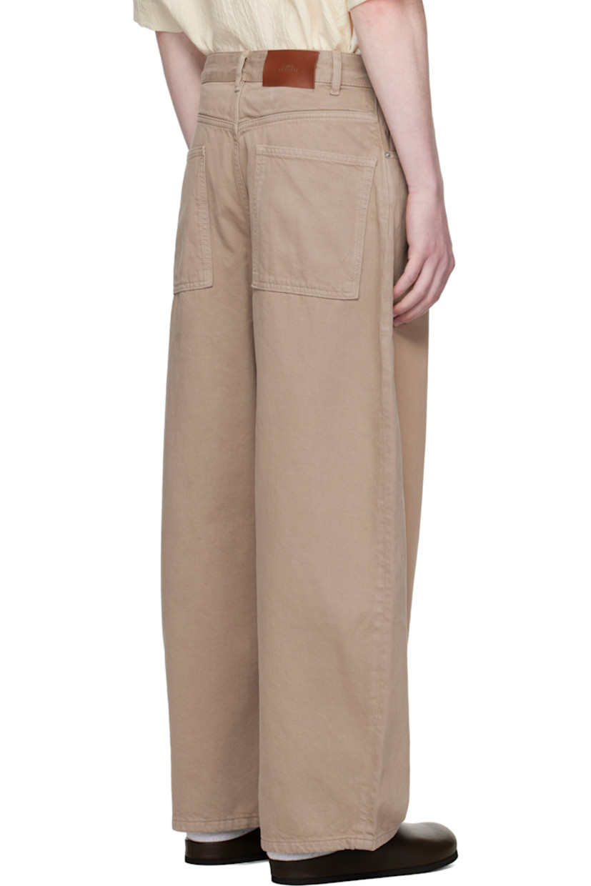 Garment-dyed non-stretch denim jeans.

· Tapered and wide-leg
· Belt loops
· Five-pocket styling
· Zip fly
· Leather logo patch at back waistband

Supplier color: Fawn