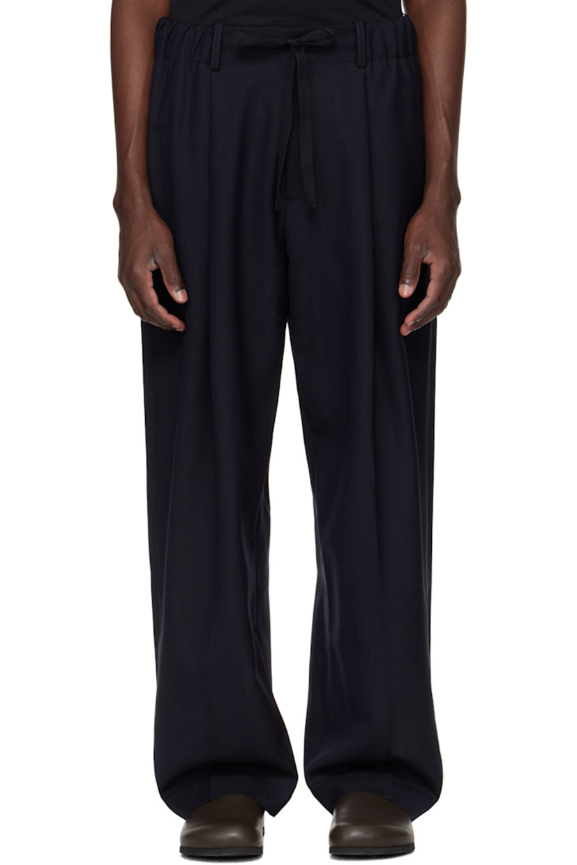 Wide-leg wool piqué trousers.

· Mid-rise
· Belt loops
· Drawstring at elasticized waistband
· Two-pocket styling
· Zip fly
· Pleats at front

Supplier color: Darkest Navy