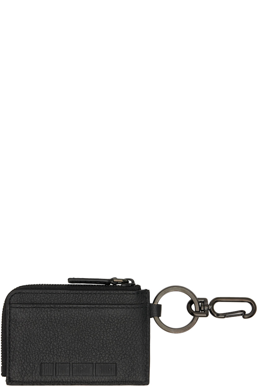 Grained leather card holder.

· Graphic appliqué at face
· Clasp and keyring at side
· Logo embossed at back face
· Two card slots
· Zip coin compartment
· H2.75" x W3.75"

Supplier color: Black