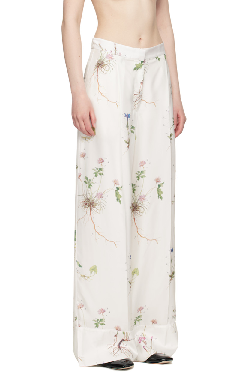 Wide-leg silk twill trousers. Printed floral pattern and piping throughout.

· High-rise
· Two-pocket styling
· Zip fly
· Pleats at front 
· Creased legs
· Vented cuffs
· Full silk voile lining

Supplier color: Botanical violet white