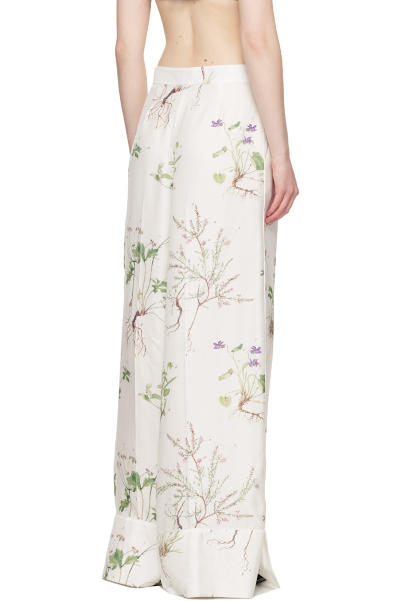Wide-leg silk twill trousers. Printed floral pattern and piping throughout.

· High-rise
· Two-pocket styling
· Zip fly
· Pleats at front 
· Creased legs
· Vented cuffs
· Full silk voile lining

Supplier color: Botanical violet white