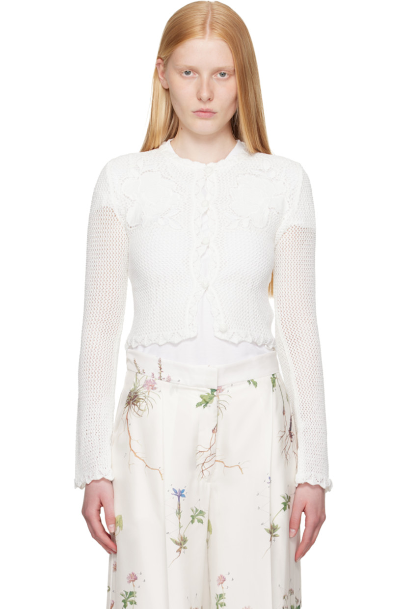 Semi-sheer open-knit cotton cardigan.

· Scalloped edge at round neck, hem, and cuffs 
· Button closure
· Embroidered floral appliqués at chest
· Cropped hem 

Supplier color: Ivory