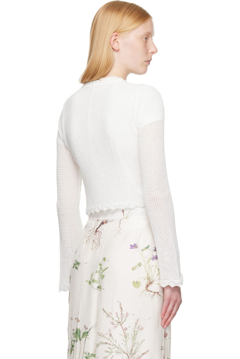 Semi-sheer open-knit cotton cardigan.

· Scalloped edge at round neck, hem, and cuffs 
· Button closure
· Embroidered floral appliqués at chest
· Cropped hem 

Supplier color: Ivory