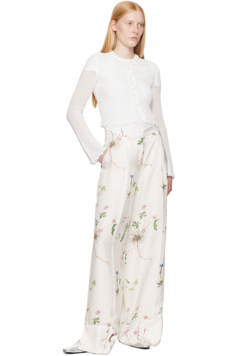 Semi-sheer open-knit cotton cardigan.

· Scalloped edge at round neck, hem, and cuffs 
· Button closure
· Embroidered floral appliqués at chest
· Cropped hem 

Supplier color: Ivory