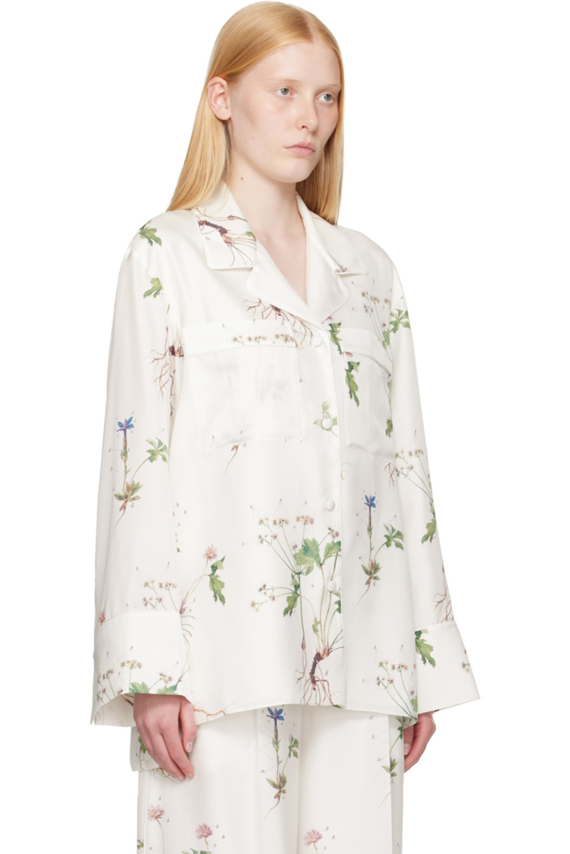 Silk twill shirt. Printed floral pattern and piping throughout.

· Notched lapel
· Button closure
· Patch pockets at chest
· Vented droptail hem
· Dropped shoulders
· Button fastening at vented cuffs

Supplier color: Botanical violet white