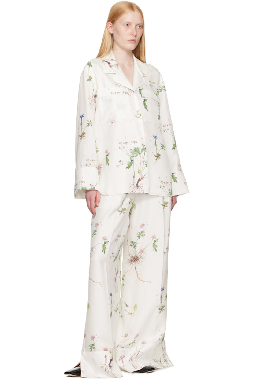 Silk twill shirt. Printed floral pattern and piping throughout.

· Notched lapel
· Button closure
· Patch pockets at chest
· Vented droptail hem
· Dropped shoulders
· Button fastening at vented cuffs

Supplier color: Botanical violet white