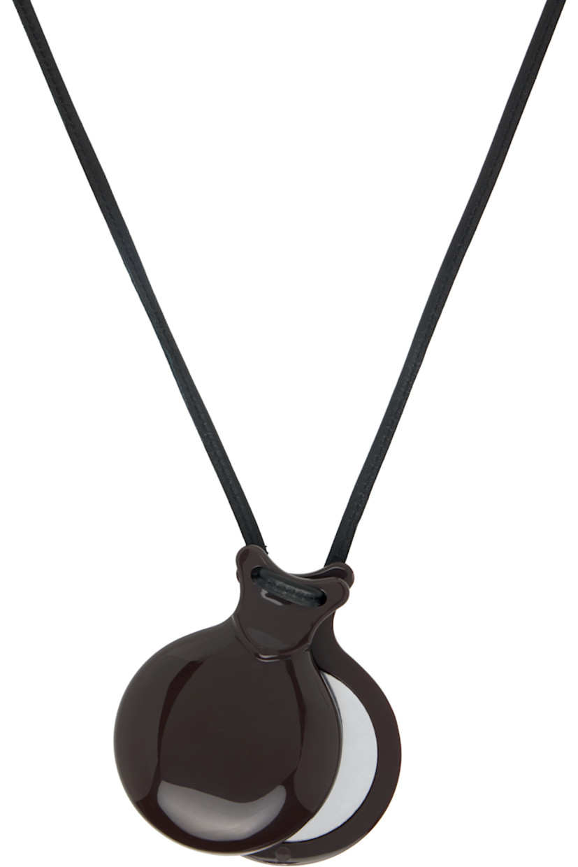 Buffed lambskin cord necklace in black.

· Acrylic pendant with mirror
· Self-tie fastening 
· L30"
· Pendant: H3" x W2.5" 

Supplier color: Dark brown