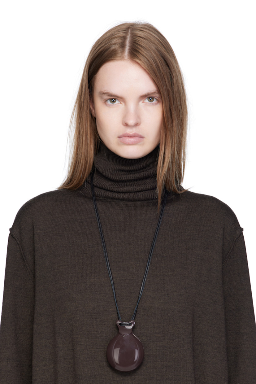 Buffed lambskin cord necklace in black.

· Acrylic pendant with mirror
· Self-tie fastening 
· L30"
· Pendant: H3" x W2.5" 

Supplier color: Dark brown