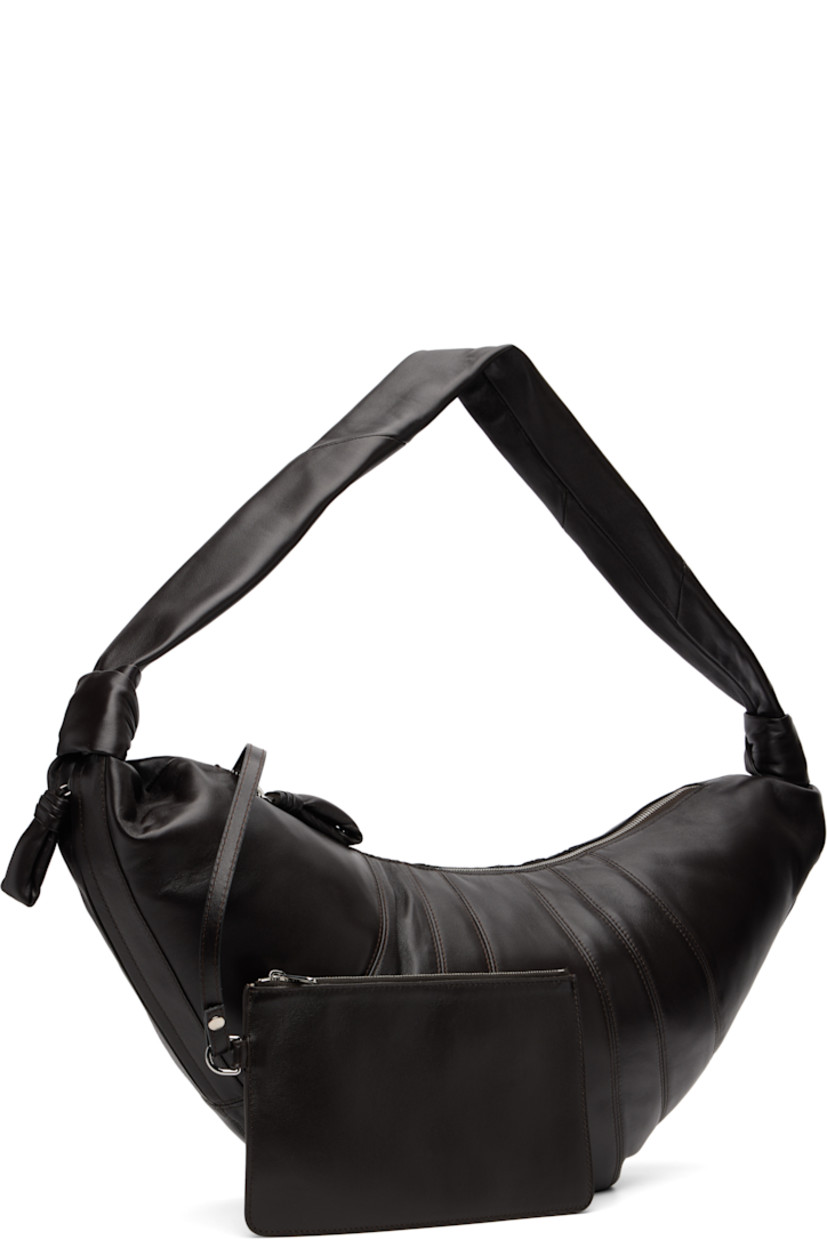 Nappa lambskin shoulder bag.

· Fixed knotted crossbody strap
· Zip pocket with padded pull-tab at side
· Padded pull-tab at zip closure
· Patch pocket at interior
· Detachable zip pouch-on-lanyard at interior
· Cotton canvas lining
· H11" x W23" x D2.5"

Supplier color: Dark chocolate