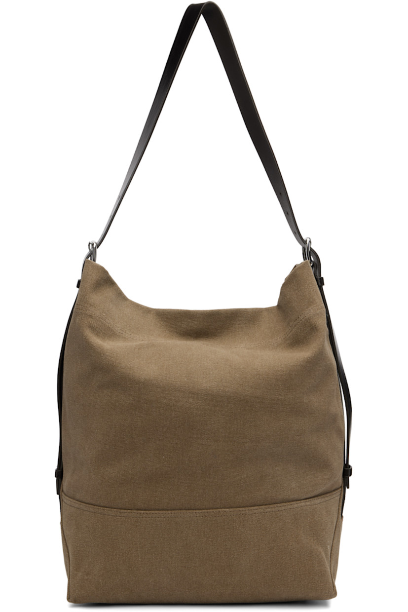 Tie-dyed cotton canvas tote. 

· Vegetable-tanned buffed leather trim throughout
· Adjustable and detachable shoulder strap
· Lanyard-clasp closure
· Zip pocket at interior 
· H15.5" x W17.5" x D6"

Supplier color: Sisal