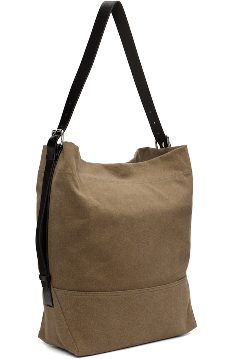 Tie-dyed cotton canvas tote. 

· Vegetable-tanned buffed leather trim throughout
· Adjustable and detachable shoulder strap
· Lanyard-clasp closure
· Zip pocket at interior 
· H15.5" x W17.5" x D6"

Supplier color: Sisal