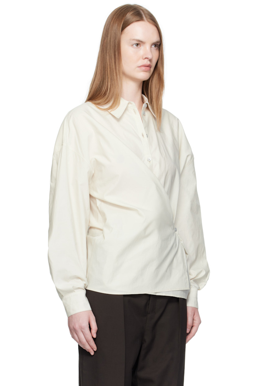 Washed cotton- and silk-blend poplin shirt.

· Spread collar
· Asymmetrical button and self-tie closure
· Dropped shoulders
· Buttoned barrel cuffs
· Gathering at back yoke

Supplier color: Light cream