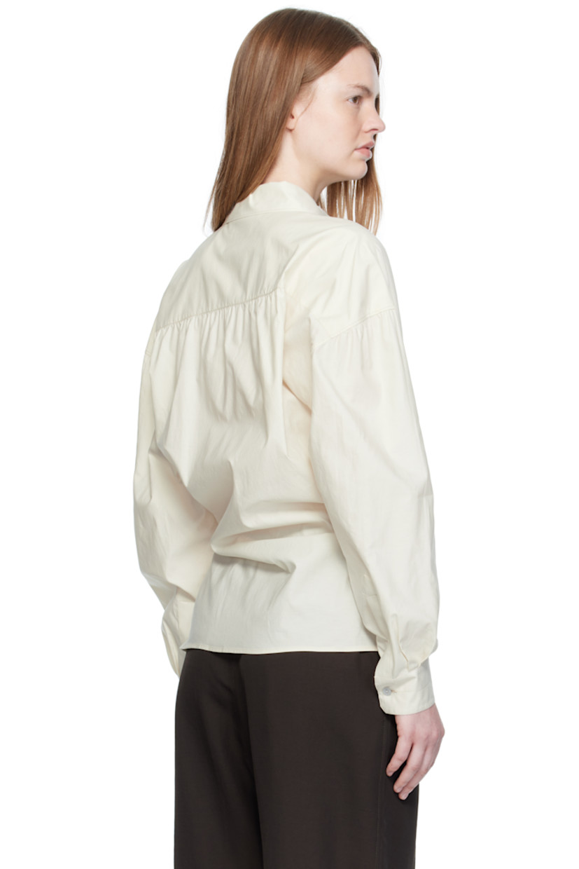 Washed cotton- and silk-blend poplin shirt.

· Spread collar
· Asymmetrical button and self-tie closure
· Dropped shoulders
· Buttoned barrel cuffs
· Gathering at back yoke

Supplier color: Light cream