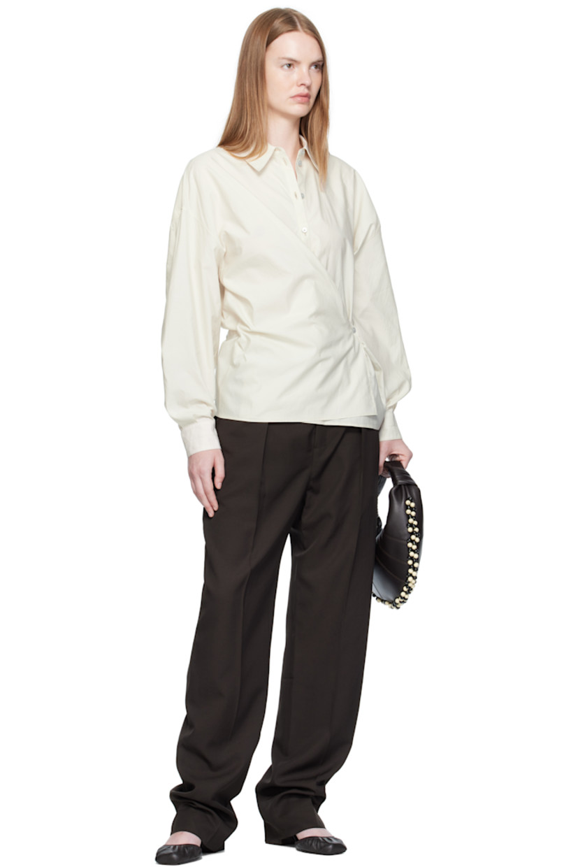 Washed cotton- and silk-blend poplin shirt.

· Spread collar
· Asymmetrical button and self-tie closure
· Dropped shoulders
· Buttoned barrel cuffs
· Gathering at back yoke

Supplier color: Light cream