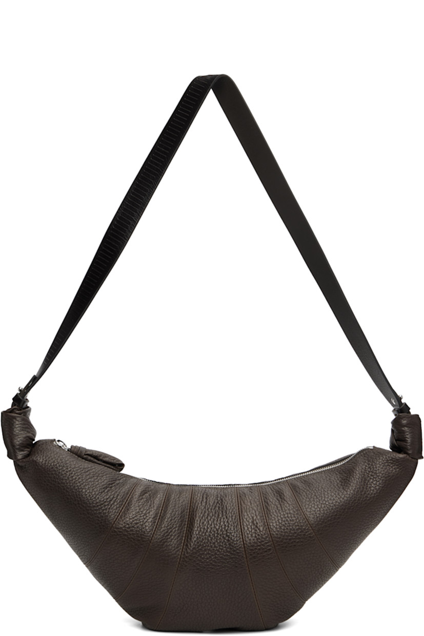 Grained leather messenger bag.

· LWG-certified leather
· Stripes embossed at fixed crossbody strap
· Zip closure
· Patch pocket at interior
· Cotton canvas lining
· H9" x W18" x D3"

Supplier color: Dark chocolate