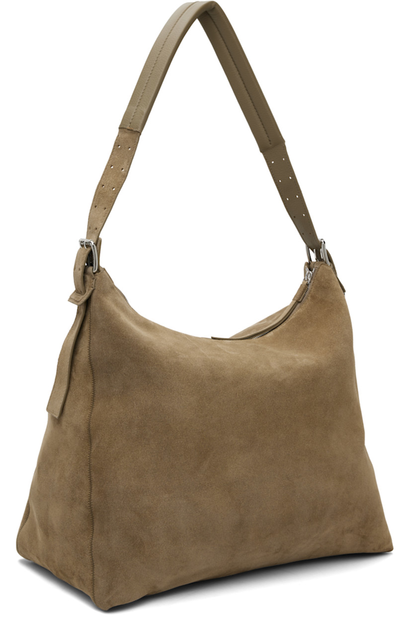 Heavyweight canvas shoulder bag.

· LWG Gold-certified leather trim throughout
· Adjustable and detachable belt-style shoulder strap
· D-ring at side
· Zip closure
· Zip pocket at interior
· Detachable base panel at interior
· Unlined
· H15" x W16" x D9"

Supplier color: Pebble