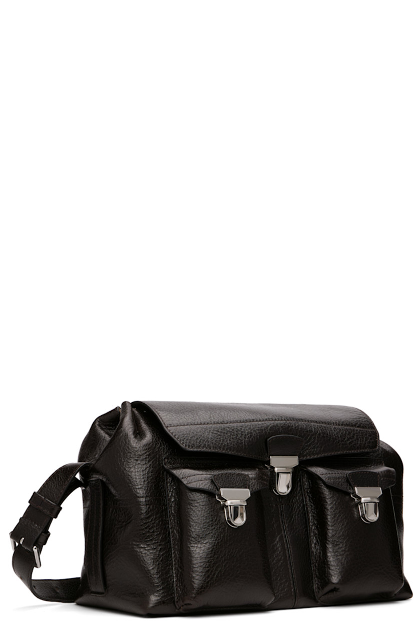 Vegetable-tanned grained leather messenger bag.

· LWG Gold-certified leather
· Adjustable crossbody strap
· Flap pockets at face
· Zip pocket and embossed logo at back face
· Press-release flap
· Zip closure
· Suede lining
· H8.5" x W13" x D7"

Supplier color: Espresso