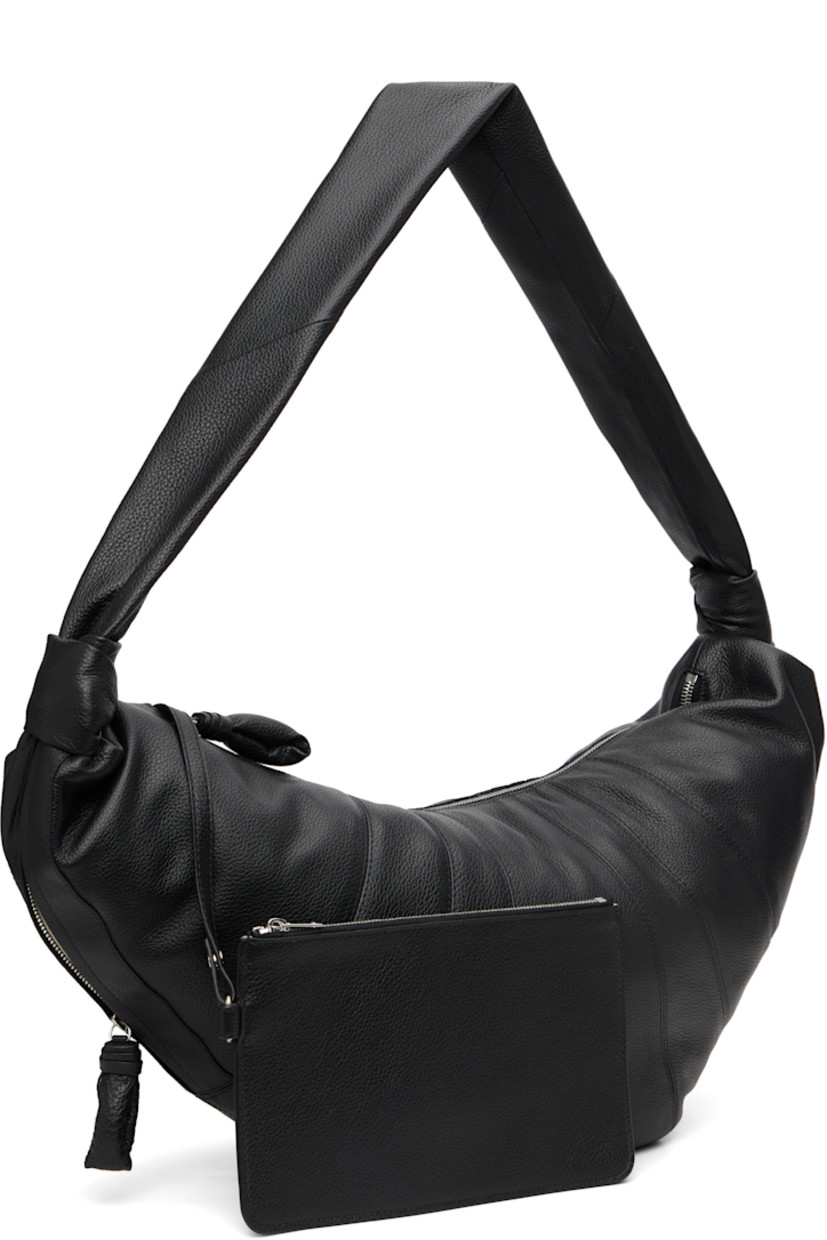 Grained leather messenger bag.

· Fixed knotted crossbody strap
· Zip pocket with padded pull-tab at side
· Padded pull-tab at zip closure
· Patch pocket at interior
· Detachable zip pouch-on-lanyard at interior
· Cotton canvas lining
· H11" x W23" x D2.5"

Supplier color: Black