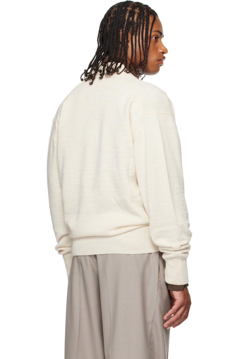 Knit acrylic-blend cardigan.

· Wrap construction 
· Rib-knit placket, hem, and cuffs
· Offset button closure

Supplier color: Light cream