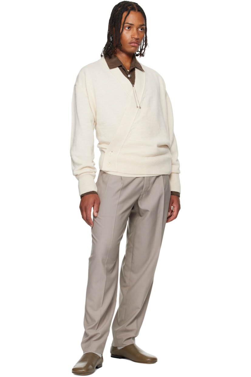 Knit acrylic-blend cardigan.

· Wrap construction 
· Rib-knit placket, hem, and cuffs
· Offset button closure

Supplier color: Light cream