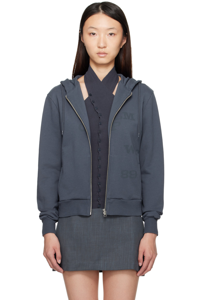 Organic cotton French terry hoodie.

· Drawstring at hood
· Zip closure
· Logo and text printed at front
· Welt pockets
· Rib-knit hem and cuffs

Supplier color: Navy