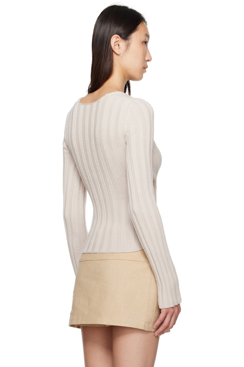 Rib-knit extrafine merino wool sweater.

· Can be worn front to back
· Wrap construction
· V-neck
· Mulesing-free wool

Supplier color: Off-white