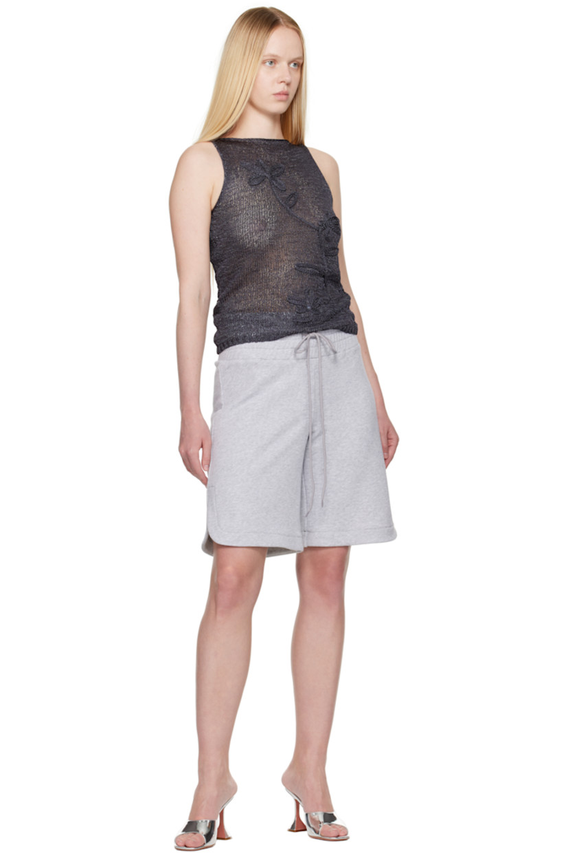 Semi-sheer FSC-certified viscose-blend tank top.

· Rolled edge at boatneck
· Floral appliqué at front
· Rib-knit hem 

Supplier color: Dark grey