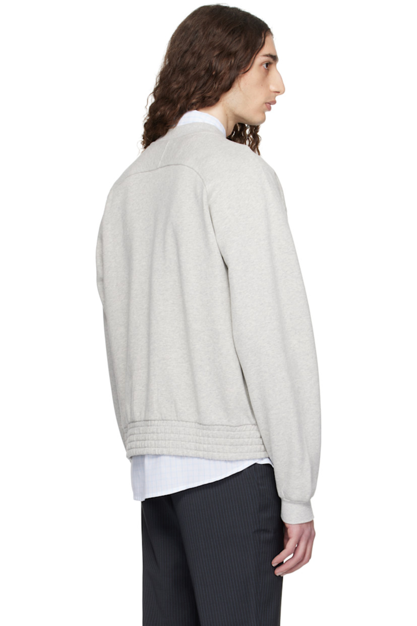 Organic cotton fleece jacket. 

· Rib-knit crewneck and cuffs
· Zip closure
· Frayed edge at placket 
· Seam pockets
· Elasticized hem 
· Raglan sleeves

Supplier color: Grey