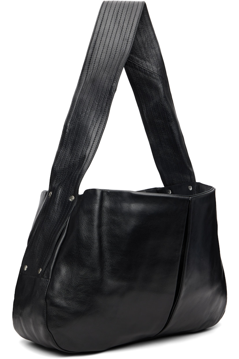 Grained leather messenger bag.

· Fixed quilted shoulder strap
· Inverted box pleat at face and back face
· Press-stud closure
· Patch pocket at interior
· Canvas lining
· H14.5" x W21" x D6.5"

Supplier color: Black