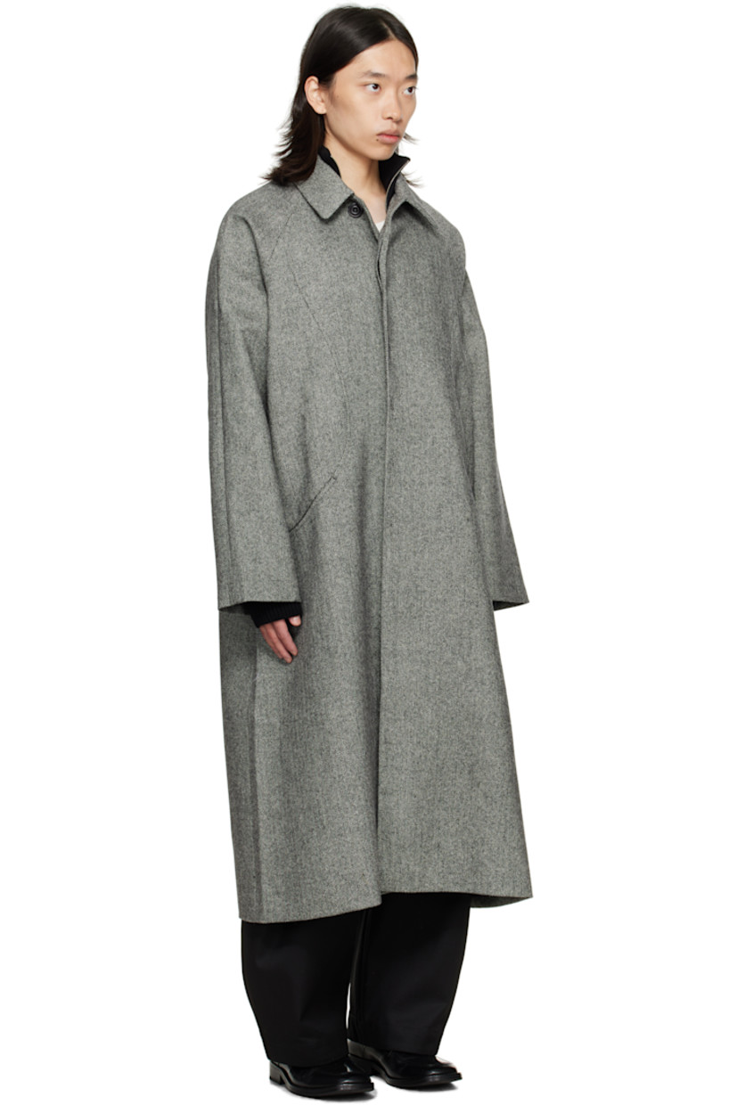 Wool tweed coat.

· Herringbone pattern throughout
· Button throat guard at spread collar
· Concealed button closure
· Welt pockets at front
· Raglan sleeves
· Patch pocket at interior
· Full satin lining

Supplier color: Black/White herringbone