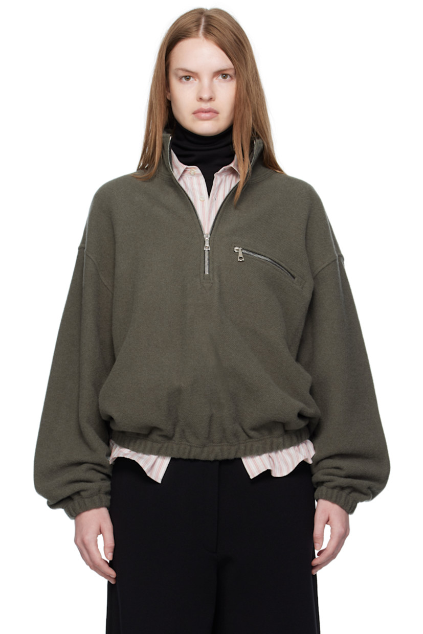 Lightweight virgin wool fleece sweater.

· Stand collar
· Half-zip closure
· Zip pocket at chest
· Elasticized hem and cuffs
· Locker loop at back yoke

Supplier color: Camoscio fleece