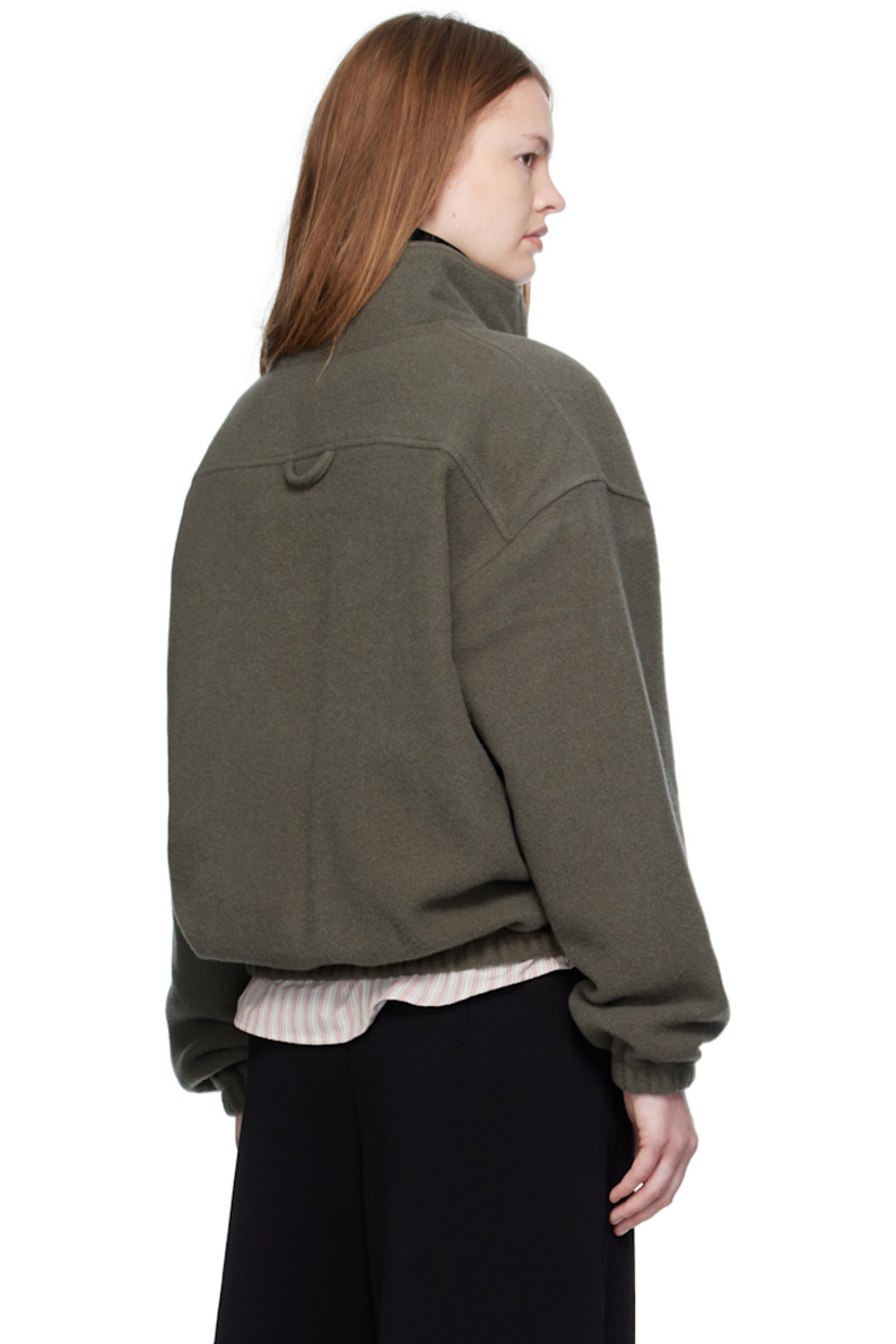 Lightweight virgin wool fleece sweater.

· Stand collar
· Half-zip closure
· Zip pocket at chest
· Elasticized hem and cuffs
· Locker loop at back yoke

Supplier color: Camoscio fleece