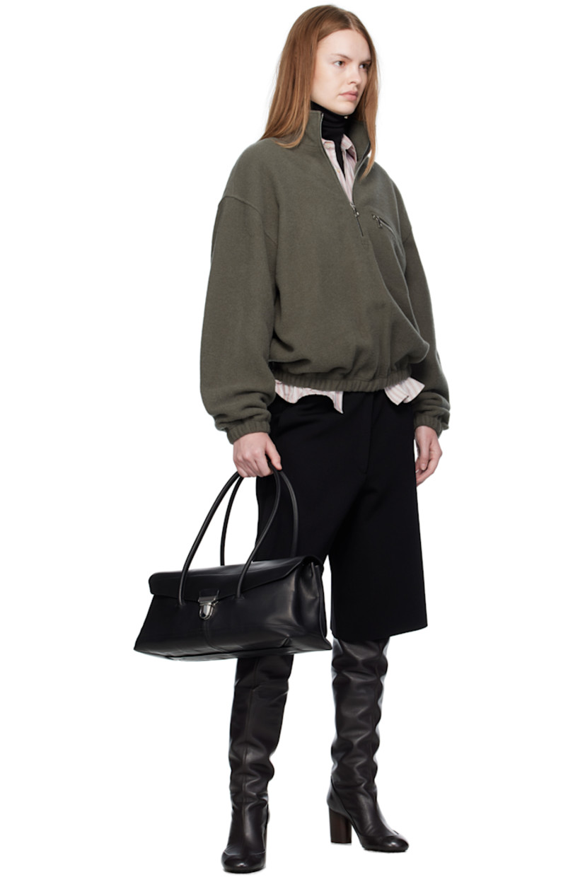 Lightweight virgin wool fleece sweater.

· Stand collar
· Half-zip closure
· Zip pocket at chest
· Elasticized hem and cuffs
· Locker loop at back yoke

Supplier color: Camoscio fleece