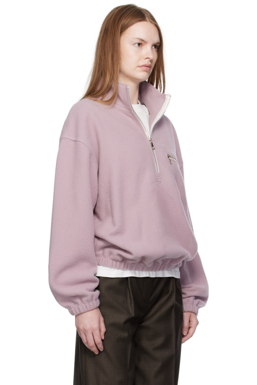 Lightweight virgin wool fleece sweater.

· Stand collar
· Half-zip closure
· Zip pocket at chest
· Elasticized hem and cuffs 
· Locker loop at back yoke

Supplier color: Myrte fleece