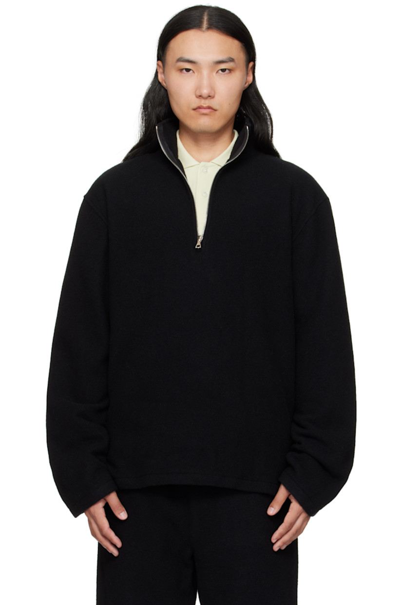 Brushed virgin wool fleece sweater.

· Stand collar
· Half-zip closure
· Tennis-tail hem
· Dropped shoulders
· Locker loop at back yoke

Supplier color: Black