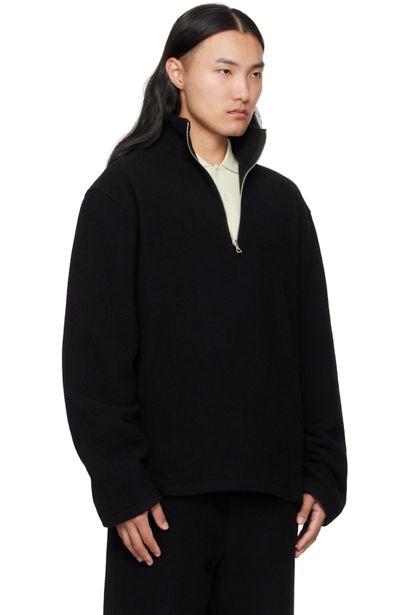 Brushed virgin wool fleece sweater.

· Stand collar
· Half-zip closure
· Tennis-tail hem
· Dropped shoulders
· Locker loop at back yoke

Supplier color: Black