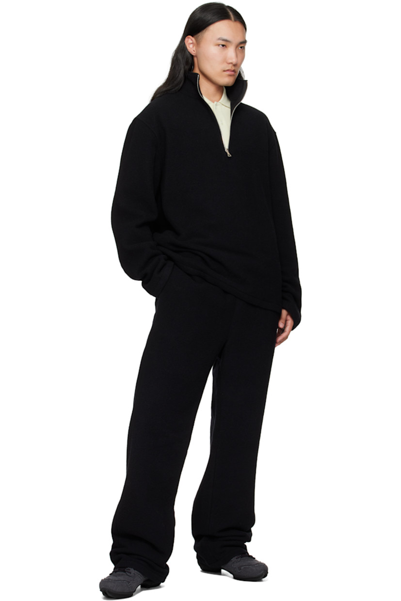 Brushed virgin wool fleece sweater.

· Stand collar
· Half-zip closure
· Tennis-tail hem
· Dropped shoulders
· Locker loop at back yoke

Supplier color: Black