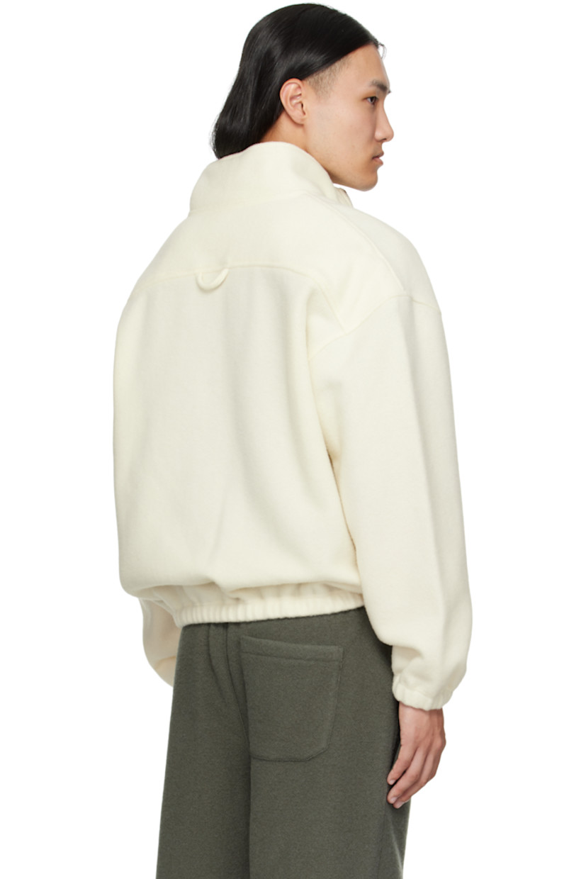 Lightweight brushed virgin wool fleece sweater.

· Stand collar
· Half-zip closure
· Zip pocket at chest
· Elasticized hem and cuffs
· Dropped shoulders
· Locker loop at back yoke

Supplier color: White