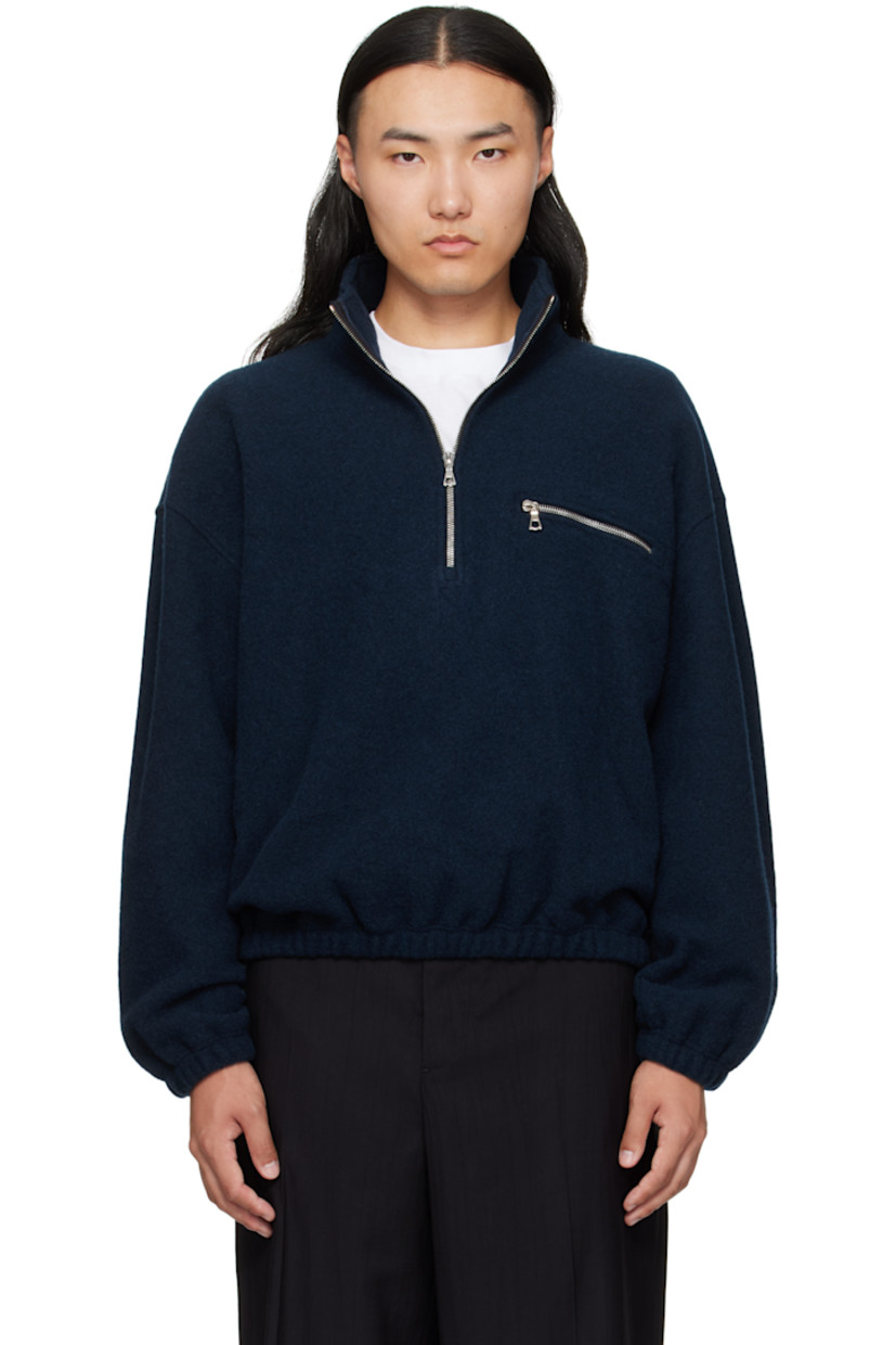 Lightweight brushed virgin wool fleece sweater.

· Half-zip closure
· Zip pocket at chest
· Elasticized hem and cuffs
· Dropped shoulders
· Locker loop at back yoke

Supplier color: Plombe