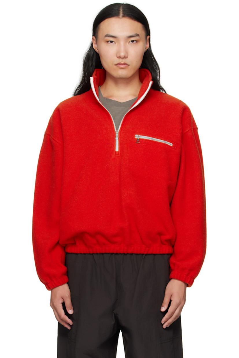 Lightweight brushed virgin wool fleece sweater.

· Half-zip closure
· Zip pocket at chest
· Elasticized hem and cuffs
· Dropped shoulders
· Locker loop at back yoke

Supplier color: Orange