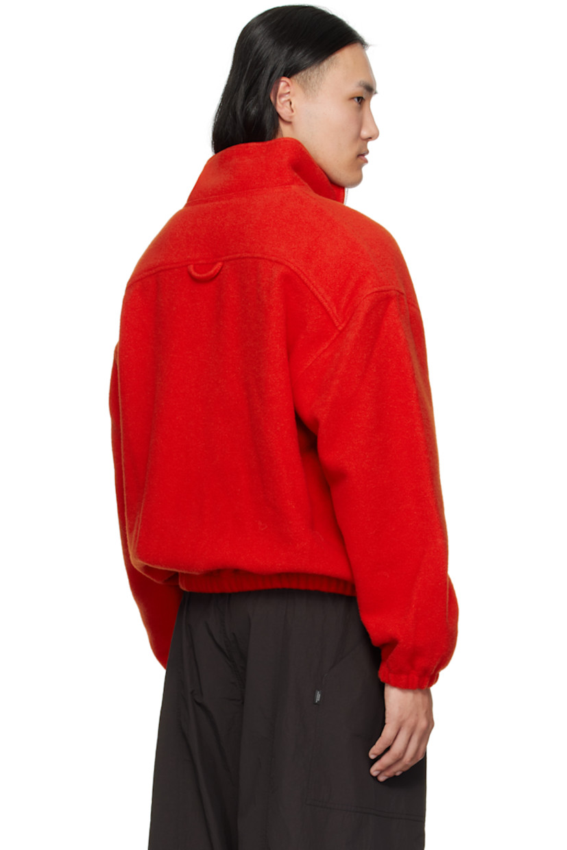 Lightweight brushed virgin wool fleece sweater.

· Half-zip closure
· Zip pocket at chest
· Elasticized hem and cuffs
· Dropped shoulders
· Locker loop at back yoke

Supplier color: Orange