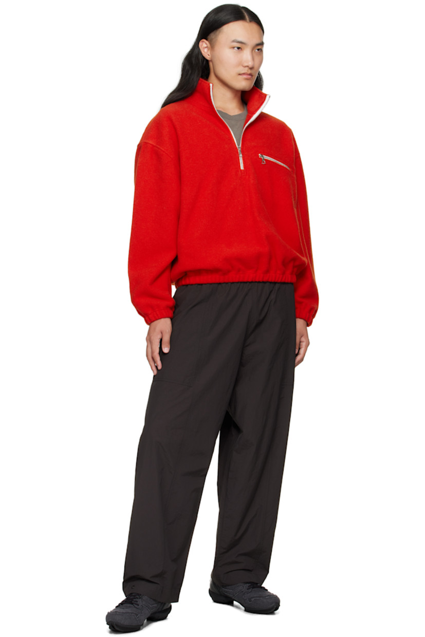 Lightweight brushed virgin wool fleece sweater.

· Half-zip closure
· Zip pocket at chest
· Elasticized hem and cuffs
· Dropped shoulders
· Locker loop at back yoke

Supplier color: Orange