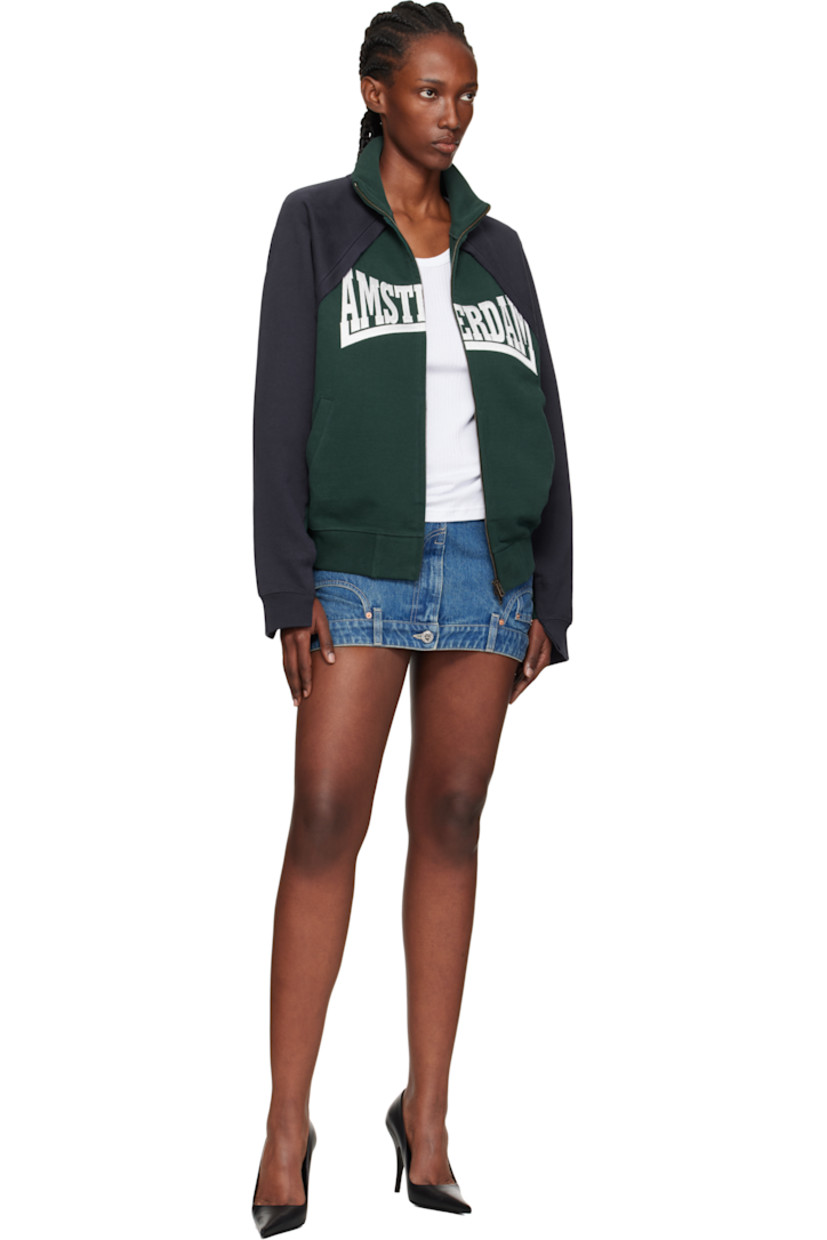 French terry sweatshirt.

· Raw edges throughout
· Paneled construction
· Stand collar
· Two-way zip closure
· Embroidered text and welt pockets at front
· Rib-knit hem and cuffs
· Raglan sleeves
· Logo embroidered at back collar

Supplier color: Emerald green/Navy