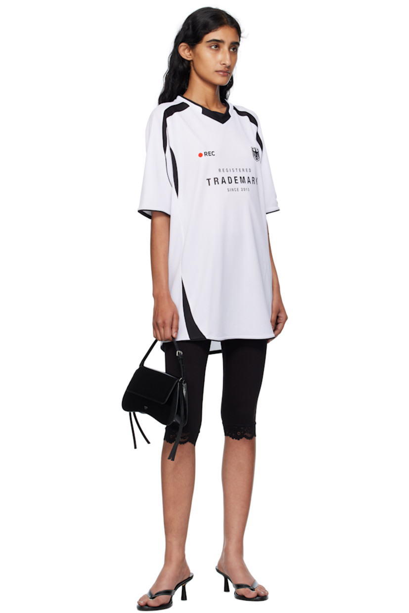 Mesh jersey.

· Paneled construction
· V-neck
· Text printed and embroidered at front and back
· Graphic embroidered at chest
· Raglan sleeves
· Logo embroidered at back 

Supplier color: White