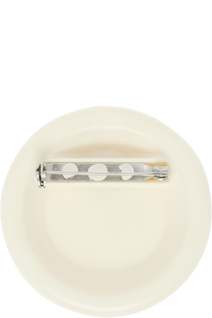 Polymer brooch.

· Logo embossed at face
· Safety-pin fastening
· D2.25"

Supplier color: White