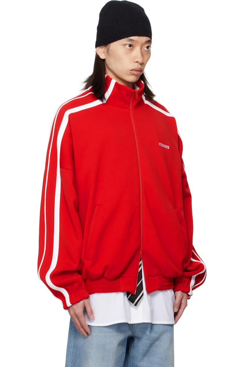 Jersey track jacket.

· Stand collar
· Two-way zip closure
· Logo embroidered at chest and back collar
· Zip pockets at front
· Elasticized hem and cuffs
· Dropped shoulders
· Stripe appliqués at sleeves
· Full mesh lining

Supplier color: Red