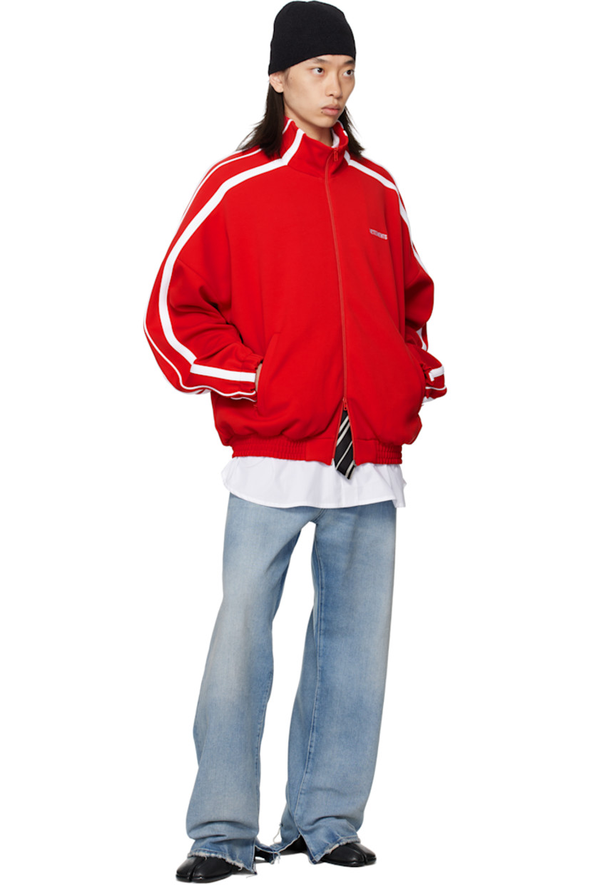 Jersey track jacket.

· Stand collar
· Two-way zip closure
· Logo embroidered at chest and back collar
· Zip pockets at front
· Elasticized hem and cuffs
· Dropped shoulders
· Stripe appliqués at sleeves
· Full mesh lining

Supplier color: Red