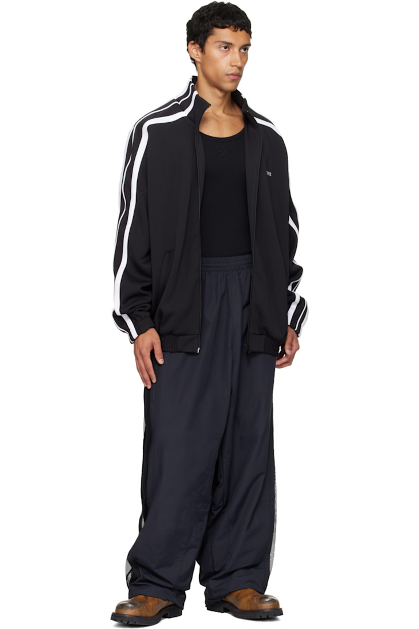 Jersey track jacket.

· Stand collar
· Two-way zip closure
· Logo embroidered at chest and back
· Zip pockets at front
· Elasticized hem and cuffs
· Dropped shoulders
· Stripe appliqués at sleeves
· Full mesh lining

Supplier color: Black
