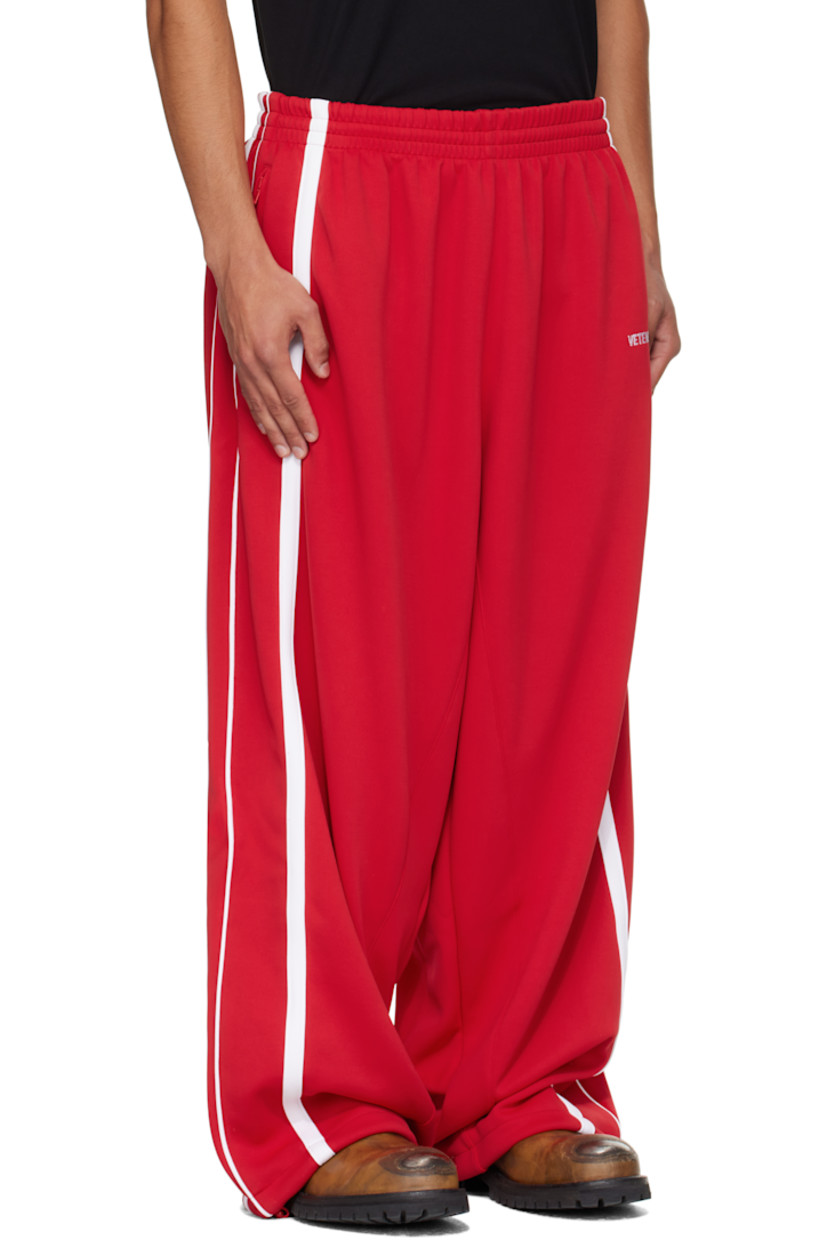 Jersey sweatpants.

· Concealed drawstring at elasticized waistband
· Three-pocket styling
· Logo embroidered at front
· Bungee-style drawstring at cuffs
· Stripes at outseams
· Full mesh lining

Supplier color: Red